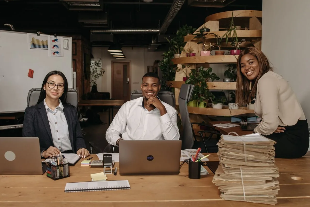 Team of employees smiling together in a modern office